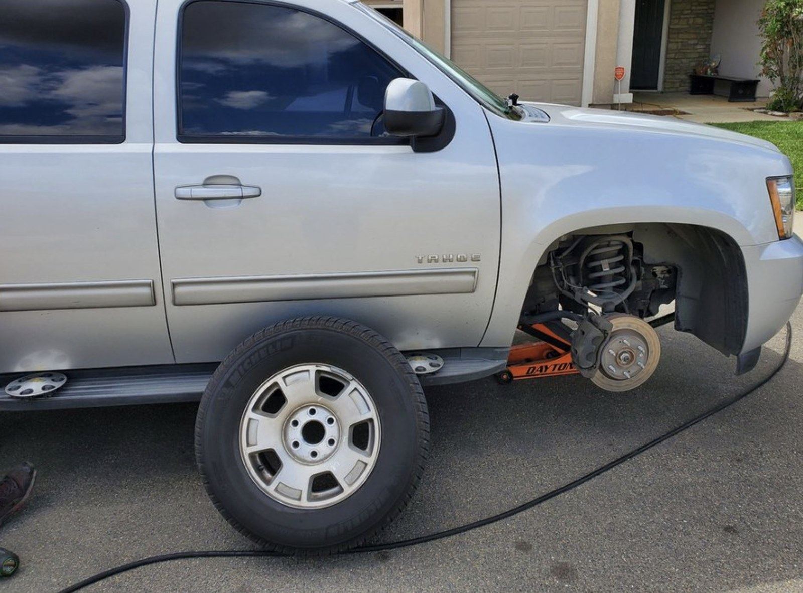 Curbside repair with the wheel off at a Lake Charles area home